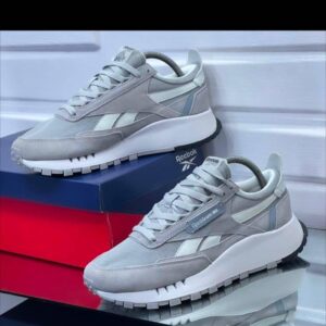 A pair of gray Reebok sneakers on display, showcasing their sleek design and comfortable features.