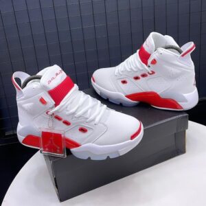 A pair of white and red Air Jordan 9 high-top sneakers displayed on a shoe box, showcasing their sleek design and vibrant color accents.