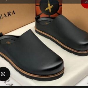 A pair of luxurious black leather clog shoes displayed on a white box with a Zara shoe box in the background, perfect for Nigeria's elite seeking high-class products.