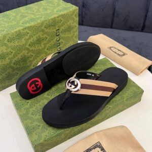 Gucci black sandals with interlocking GG logo on a green box and dust bag, perfect for adding a luxurious touch to any outfit.