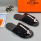Luxury black slide sandals with rhinestone straps and a sleek design, presented with an Hermes Paris box and packaging, available at Levonteluxe in Nigeria.