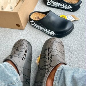 Luxury clogs with cracked design, displayed with box and tag, showcasing high-class style and comfort.