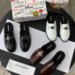 A luxurious display of Dolce & Gabbana loafers in black, brown, and white, accompanied by their signature boxes and packaging, showcasing the brand's attention to detail and commitment to high-class products.