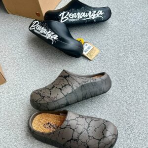 Luxury clogs with cracked design, displayed with box and tag, showcasing high-class style and comfort.