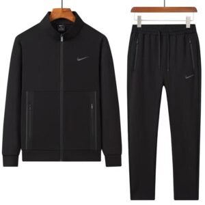 A luxurious tracksuit consisting of a gray zip-up jacket and matching gray sweatpants, both adorned with the Nike logo, hanging on wooden hangers against a white background.