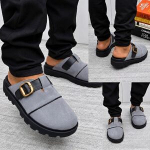 A stylish pair of grey suede half shoes with a gold buckle, showcased from multiple angles, exuding luxury and sophistication.