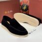 A pair of luxurious black velvet loafers from Loro Piana, showcased with their sleek design and rich texture, perfect for those who appreciate high-class products.