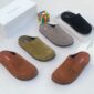 A stylish arrangement of luxurious half shoes in various colors, presented with their boxes and a touch of elegance.